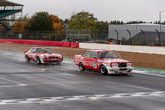 Bastos Volvo 242T leads overr the line from the Bastos Chevrolet Camaro